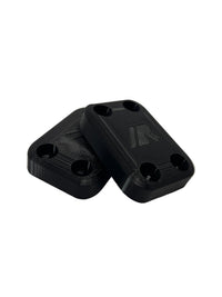 A pair of crazy cart skid plates in black with white background. 
