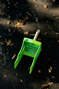 Green rdelta crazy cart fork on asphalt background. 