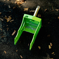 Green RDelta crazy cart fork on asphalt with leaves. 