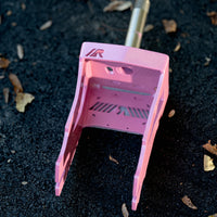 Pink RDelta crazy cart fork on a black background with leaves. 