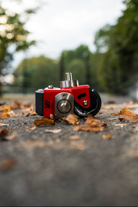 A pair of red crazy cart wide casters on a path. 